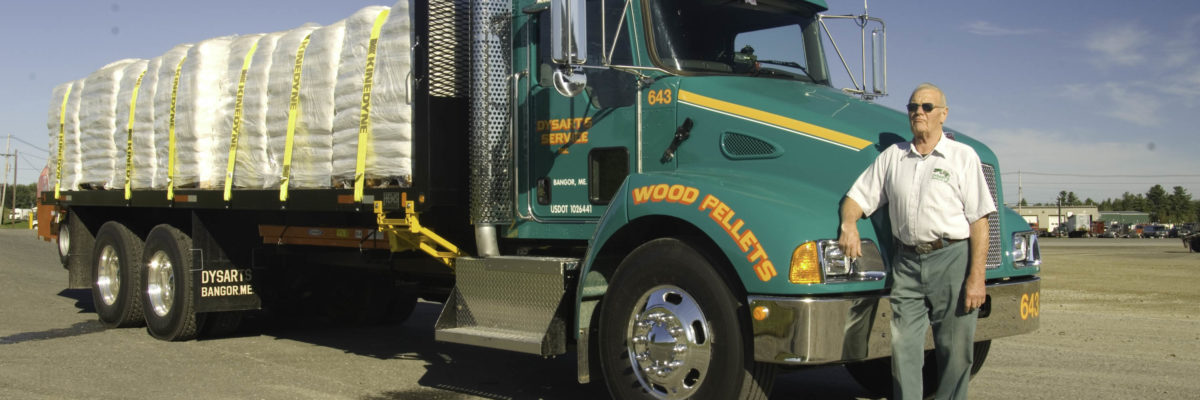 photo of man standing next to dysart's service wood pellets truck